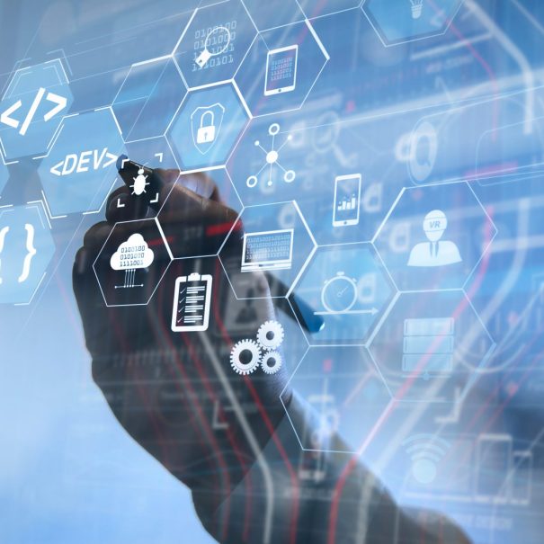 A person’s hand interacts with a transparent digital interface displaying hexagonal icons related to software development, coding, and technology.